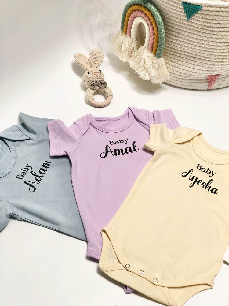 personalised baby onesies in a variety of colours